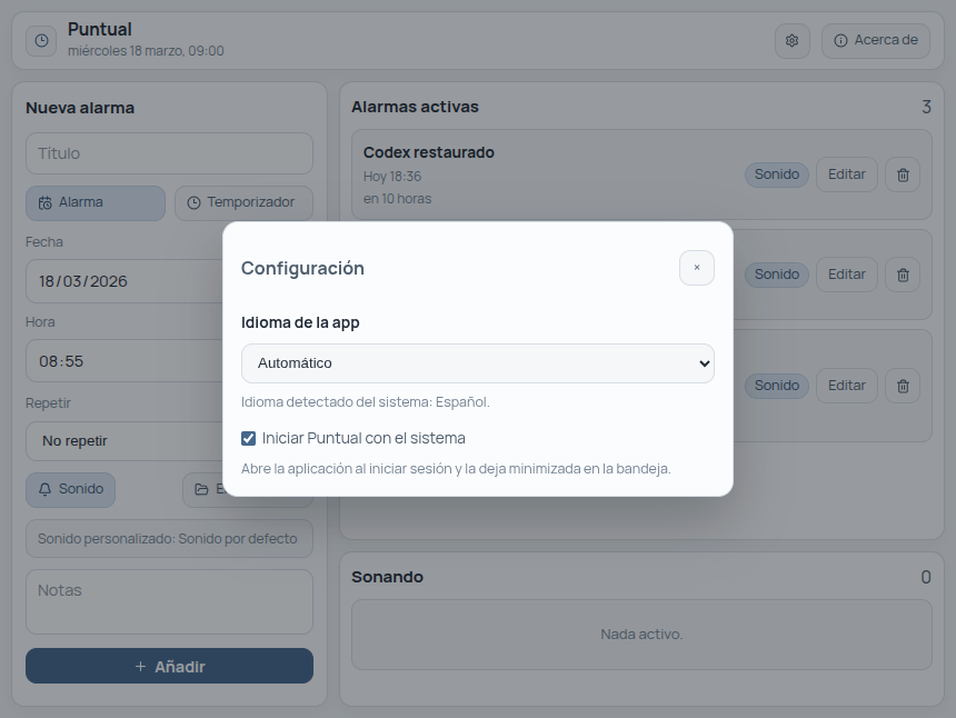 Ventana de configuración de Puntual con selector de idioma y opción de iniciar con el sistema.